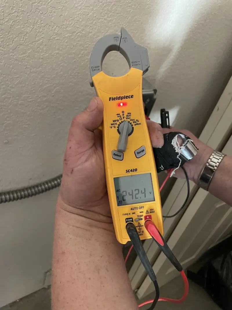 Voltage testing with clamp meter during Ceiling Fan Installation in Licking